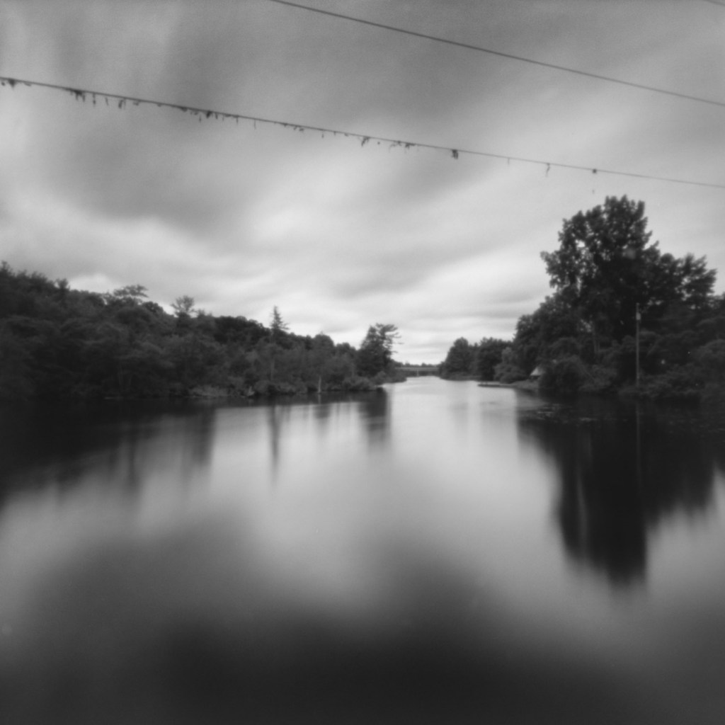 Ondu pinhole, long exposure analog photography on Fujifilm Acros II, part of the Betwixt and Between series exploring psychological landscapes along the Rideau Canal. Location: Upper Brewers Mill, downstream view.