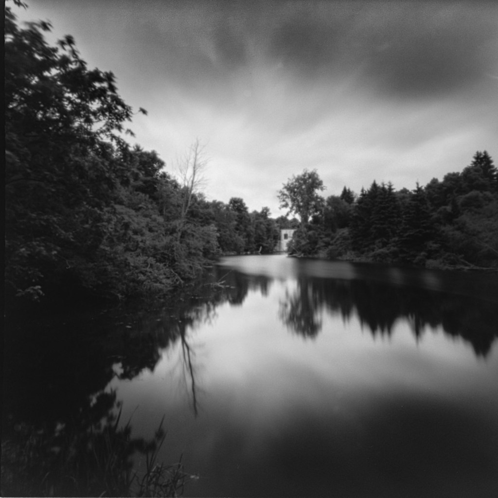 Ondu pinhole, long exposure analog photography on Fujifilm Acros II, part of the Betwixt and Between series exploring psychological landscapes along the Rideau Canal. Location: Upper Brewers Mill, upstream view.