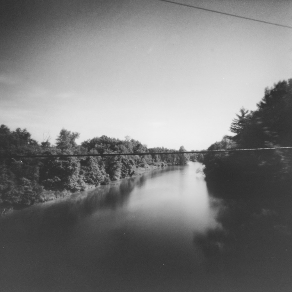 Ondu pinhole, long exposure analog photography on Fujifilm Acros II, part of the Betwixt and Between series exploring psychological landscapes along the Rideau Canal. Location: Sunbury Road bridge, upstream view.