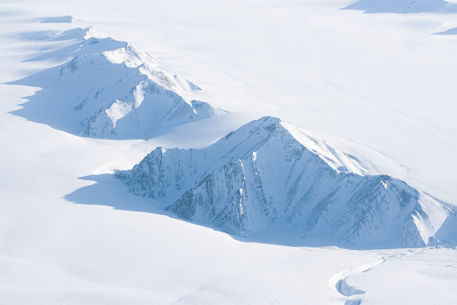 Aerial photo of snow-covered mountains on Ellesmere Island, High Arctic, Canada, Op NUNALIVUT 2008.