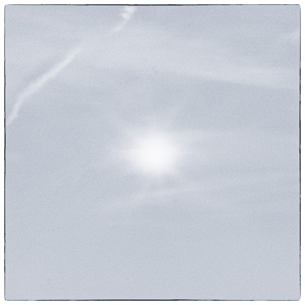 Minimal long-exposure black and white photograph of light and cloud over Lake Ontario in Kingston, with most visual detail dissolved into soft tonal fields.