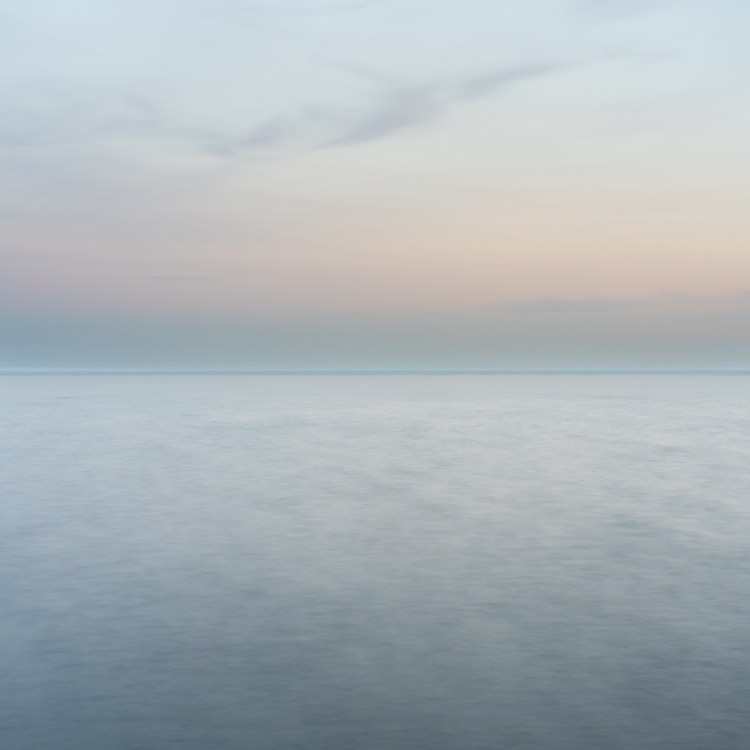 Soft pastel horizon over calm Lake Ontario water at dusk, photographed from Upper Gap Archaeological Site with a long exposure.