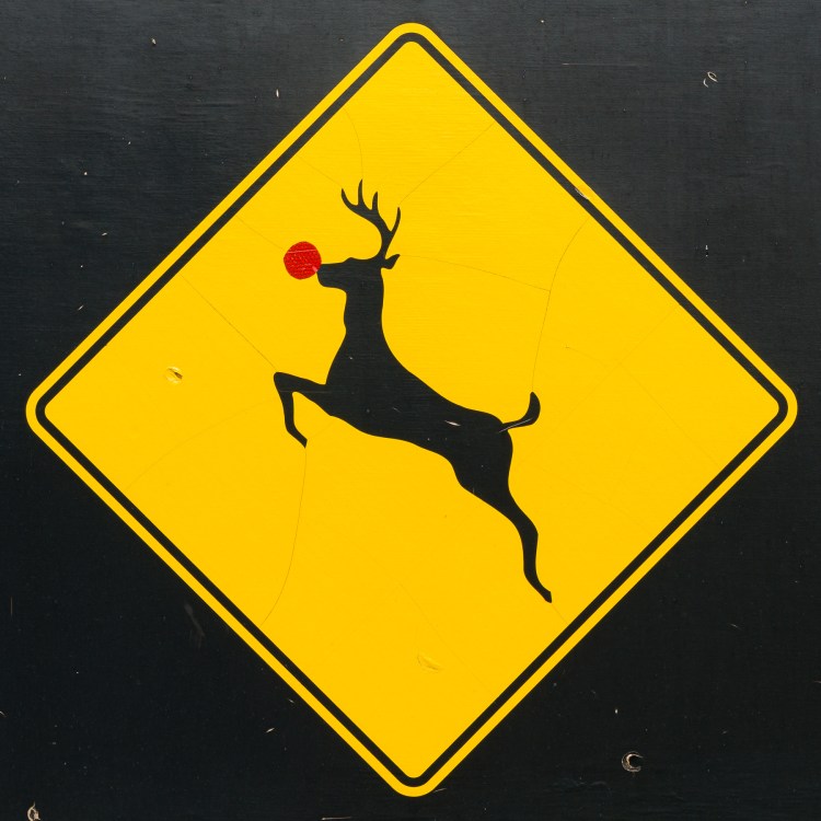 Deer crossing sign altered with a red reflective nose